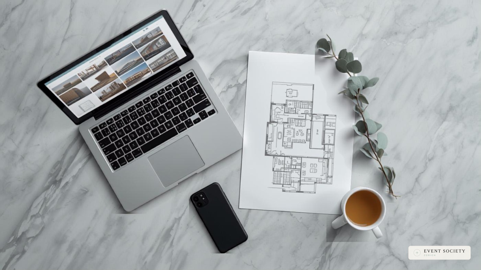 Venue photos, floor plans, a notebook and coffee laid out side by side while comparing event venues